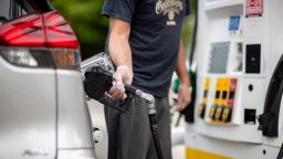 A man pumps gas at a Shell gas station in Dix Hills, New York on July 8, 2021. 