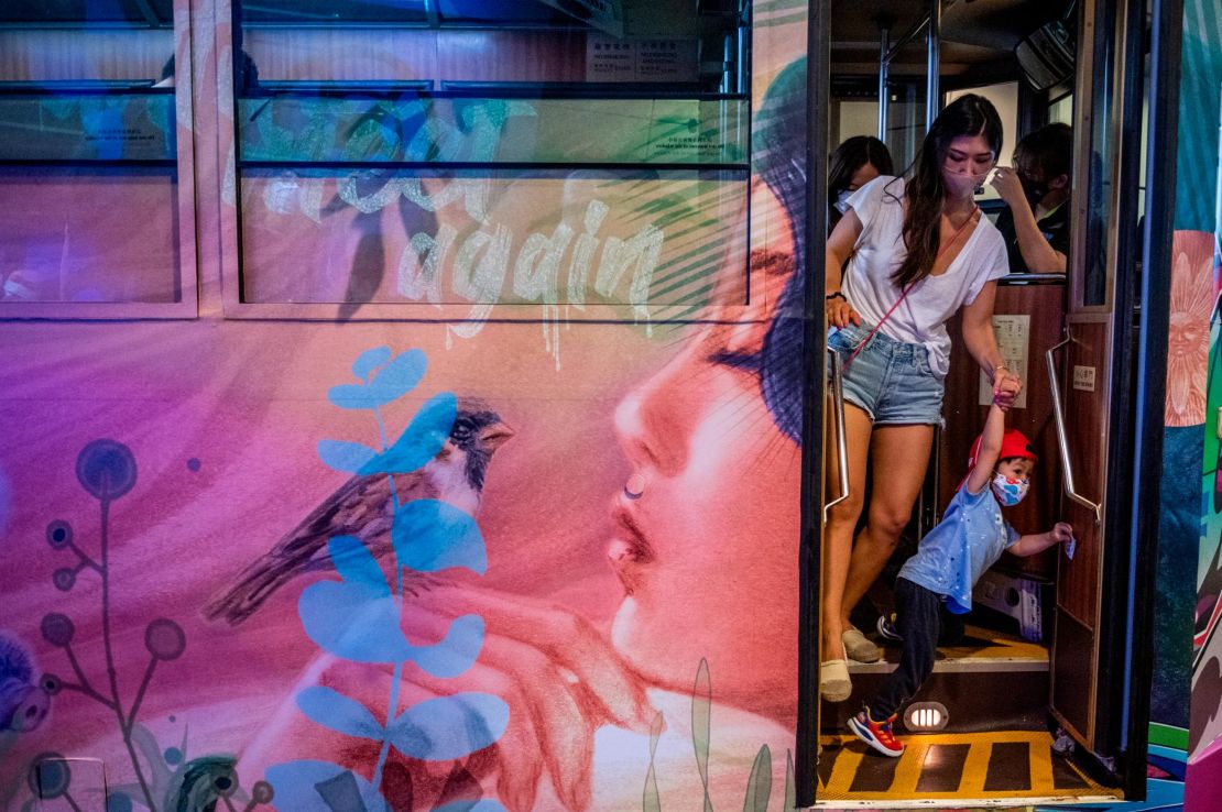 A woman and child exit a Hong Kong tram on June 26, 2021. The city has reported few Covid cases in recent months. 