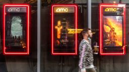 A pedestrian walks past film posters at the AMC Lincoln Square 13 movie theater in New York, U.S., on Thursday, June 10, 2021. More board members at AMC Entertainment Holdings Inc. are rushing to lock in gains from the movie-theater giant's Reddit-fueled stock surge, making another wave of sales this week. Photographer: Jeenah Moon/Bloomberg via Getty Images