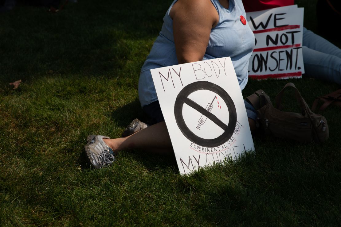 Demonstrators gather with signs to protest against mandated vaccines outside of the Michigan State Capitol on August 6, 2021 in Lansing, Michigan. 