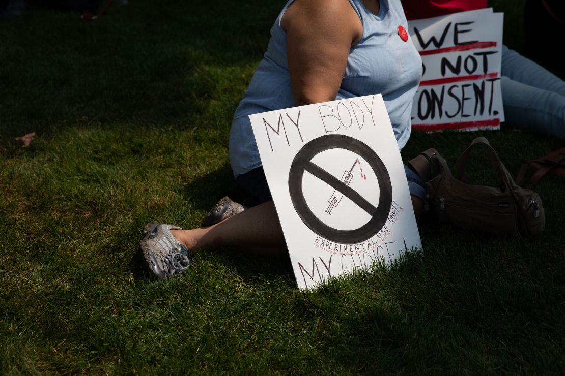 Demonstrators gather with signs to protest against mandated vaccines outside of the Michigan State Capitol on August 6, 2021 in Lansing, Michigan.