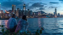 HONG KONG, CHINA - JULY 30: A couple enjoy their moment at a typhoon shelter during sunset in front of Hong Kong skyline on July 30, 2020 in Hong Kong, China. Hong Kong have recorded the highest daily tally of Covid-19 with 149 confirmed cases. (Photo by Anthony Kwan/Getty Images)