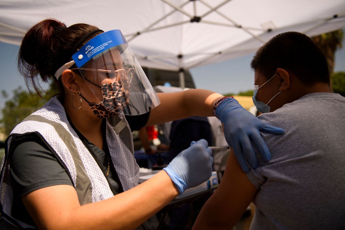 A 12-year-old receives a first dose of the Pfizer Covid-19 vaccine at a mobile vaccination clinic during a back to school event in Los Angeles.