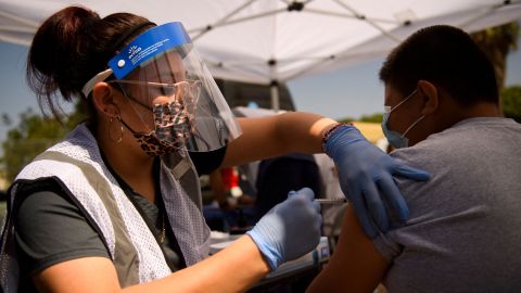 A 12-year-old receives a first dose of the Pfizer Covid-19 vaccine at a mobile vaccination clinic during a back to school event in Los Angeles.