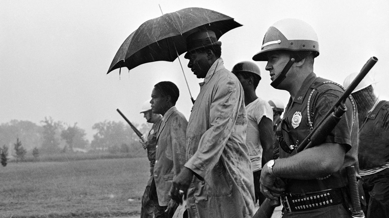 Lincoln Lynch, left, associate director of CORE, and A.Z. Young, president of the Bogalusa Voters League, march, with armed police guard flanking them, as they neared the Louisiana state Capitol in Baton Rouge on August 19, 1967. 