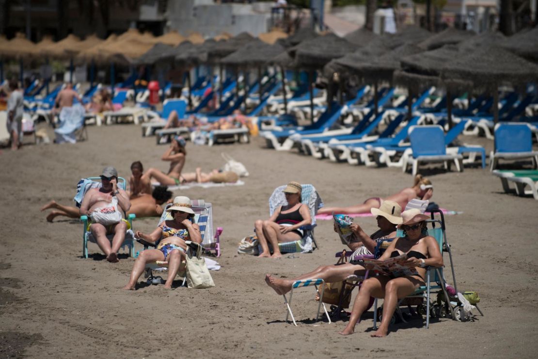 Tourists sunbathe in Marbella, Spain, in June.