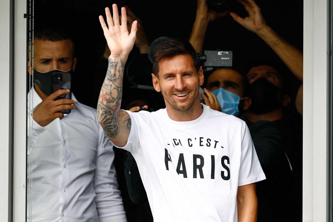 Messi waves to supporters from a window after he landed in Paris on August 10, 2021.