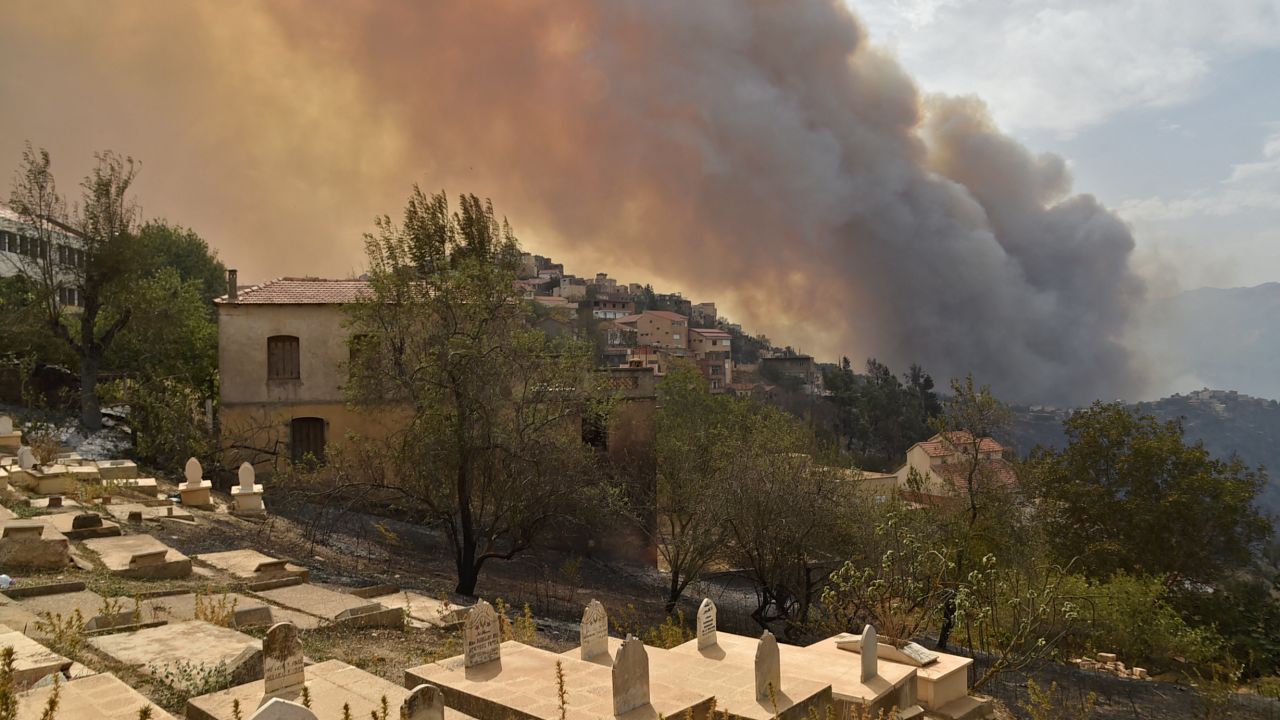 Smoke billows from a wildfire in the forested hills of the Kabylie region, east of the capital Algiers, on August 10, 2021. - Wildfires fanned by blistering temperatures and tinder-dry conditions have killed at least seven people in Algeria, the interior minister said, adding the fires had criminal origins.