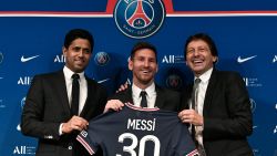 TOPSHOT - Paris Saint-Germain's Qatari President Nasser Al-Khelaifi (L) and Paris Saint-Germain's Sporting Director Leonardo Nascimento de Araujo (R) pose along side Argentinian football player Lionel Messi (C) as he holds-up his number 30 shirt during a press conference at the French football club Paris Saint-Germain's (PSG) Parc des Princes stadium in Paris on August 11, 2021. - The 34-year-old superstar signed a two-year deal with PSG on August 10, 2021, with the option of an additional year, he will wear the number 30 in Paris, the number he had when he began his professional career at Spain's Barca football club. (Photo by STEPHANE DE SAKUTIN / AFP) (Photo by STEPHANE DE SAKUTIN/AFP via Getty Images)