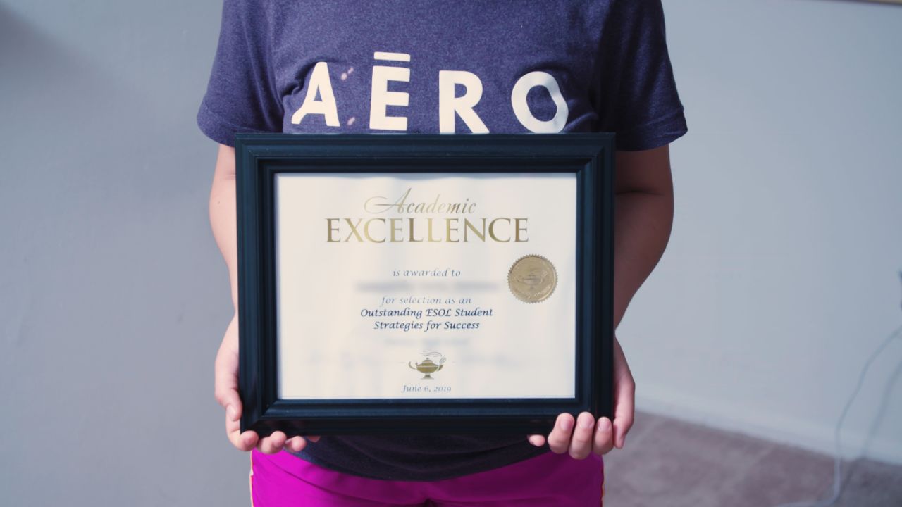 Montserrat holds an academic excellence award she won at her school in 2019.
