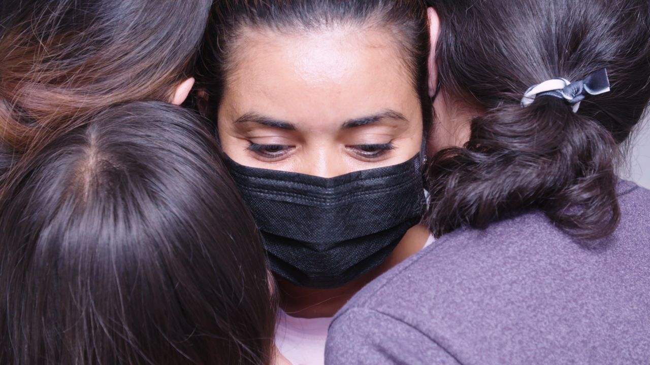 Juana hugs three of her daughters, about a month after they were reunited in the United States.