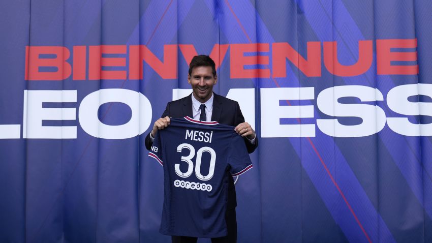 Lionel Messi holds his jersey after a press conference Wednesday, Aug. 11, 2021 at the Parc des Princes stadium in Paris. Lionel Messi said he's been enjoying his time in Paris "since the first minute" after he signed his Paris Saint-Germain contract on Tuesday night. The 34-year-old Argentina star signed a two-year deal with the option for a third season after leaving Barcelona. (AP Photo/Francois Mori)