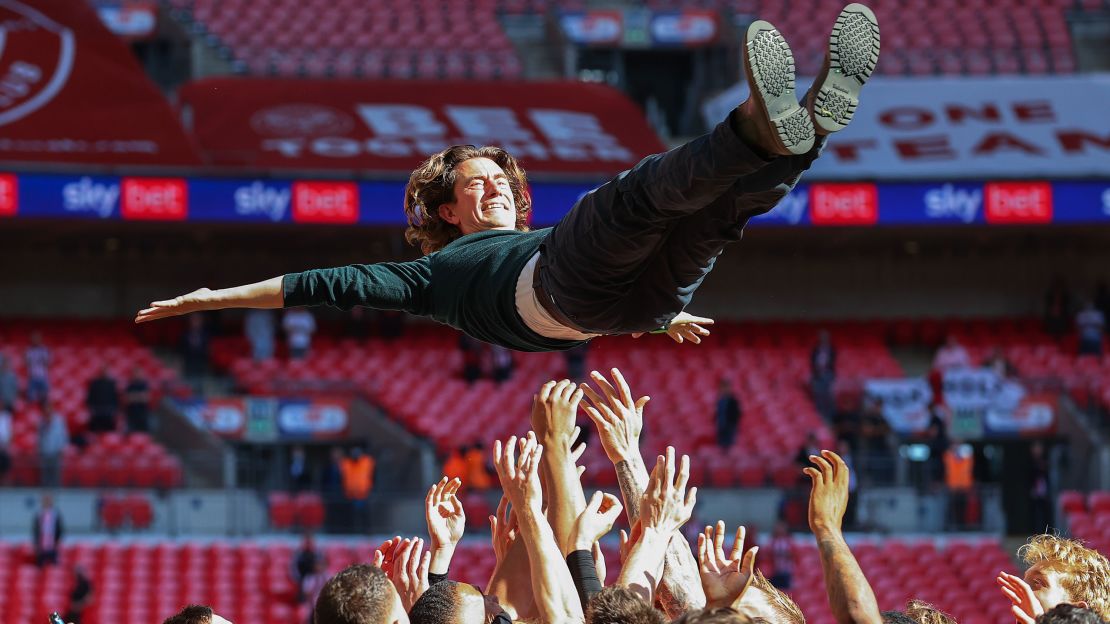 Brentford manager Thomas Frank is thrown in the air after the team's Championship playoff final success against Swansea City.