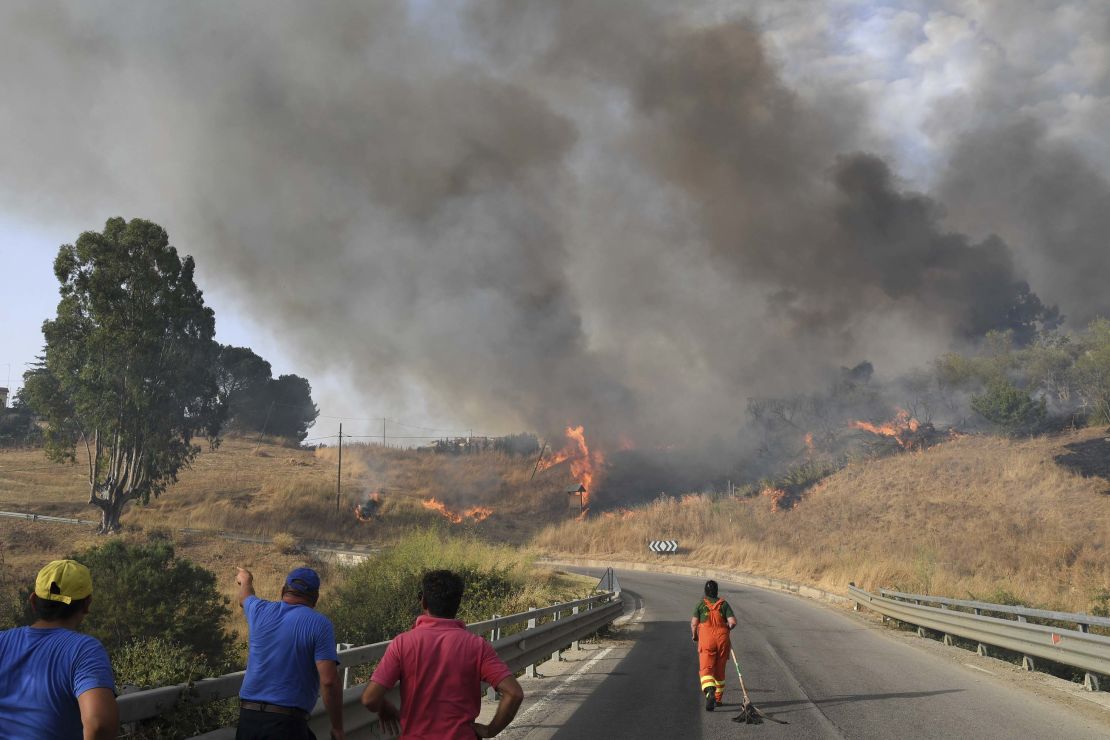 Volunteers try to control fire in the Municipality of Blufi near Palermo, Sicily, Italy.