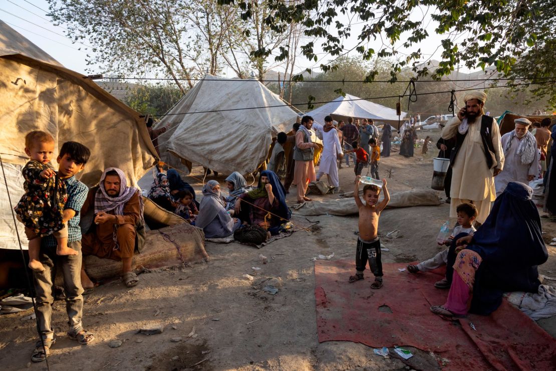 Displaced Afghans arrive at a makeshift camp in Kabul on  August 10, 2021.