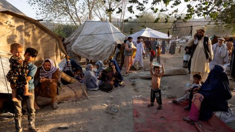 Displaced Afghans arrive at a makeshift camp in Kabul on  August 10, 2021.