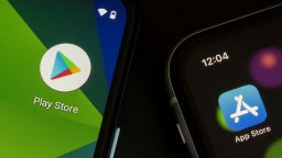 Portland, OR, USA - Apr 21, 2021: Google Play Store and Apple App Store icons are seen respectively on a Google Pixel smartphone and an iPhone.
