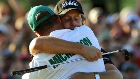 Mickelson hugs his caddie Jim "Bones" Mackay after sinking his putt on the 18th hole to win the 2010 Masters.