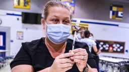 LONGWOOD, FLORIDA, UNITED STATES - 2021/08/09: A nurse prepares a dose of the Pfizer vaccine at a COVID-19 vaccine clinic at Lyman High School in Longwood on the day before classes begin for the 2021-22 school year. Seminole County Public Schools have implemented a face covering/mask mandate for students for 30 days unless a parent chooses to opt out of the requirement. (Photo by Paul Hennessy/SOPA Images/LightRocket via Getty Images)