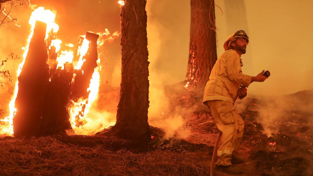 A firefighter battles the Dixie Fire near Taylorsville, California, on August 10.