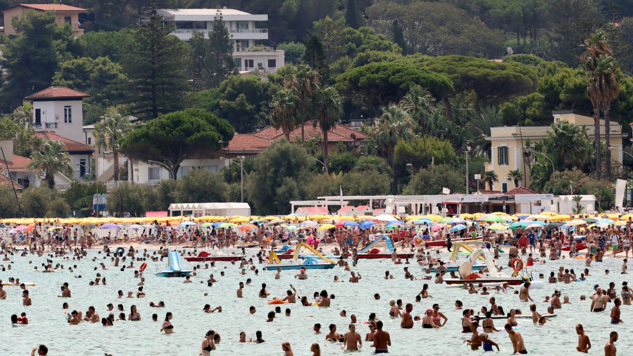 People cool down in the sea in Sicily's Palermo on Wednesday.