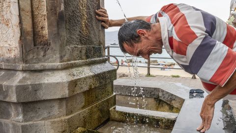 A man finds some reprieve form the heat in Messina on the Italian island of Sicily on Wednesday. 