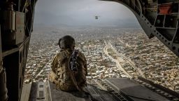  An American soldier on a CH-47 Chinook helicopter flies over Kabul, Afghanistan, on May 2, 2021. 
