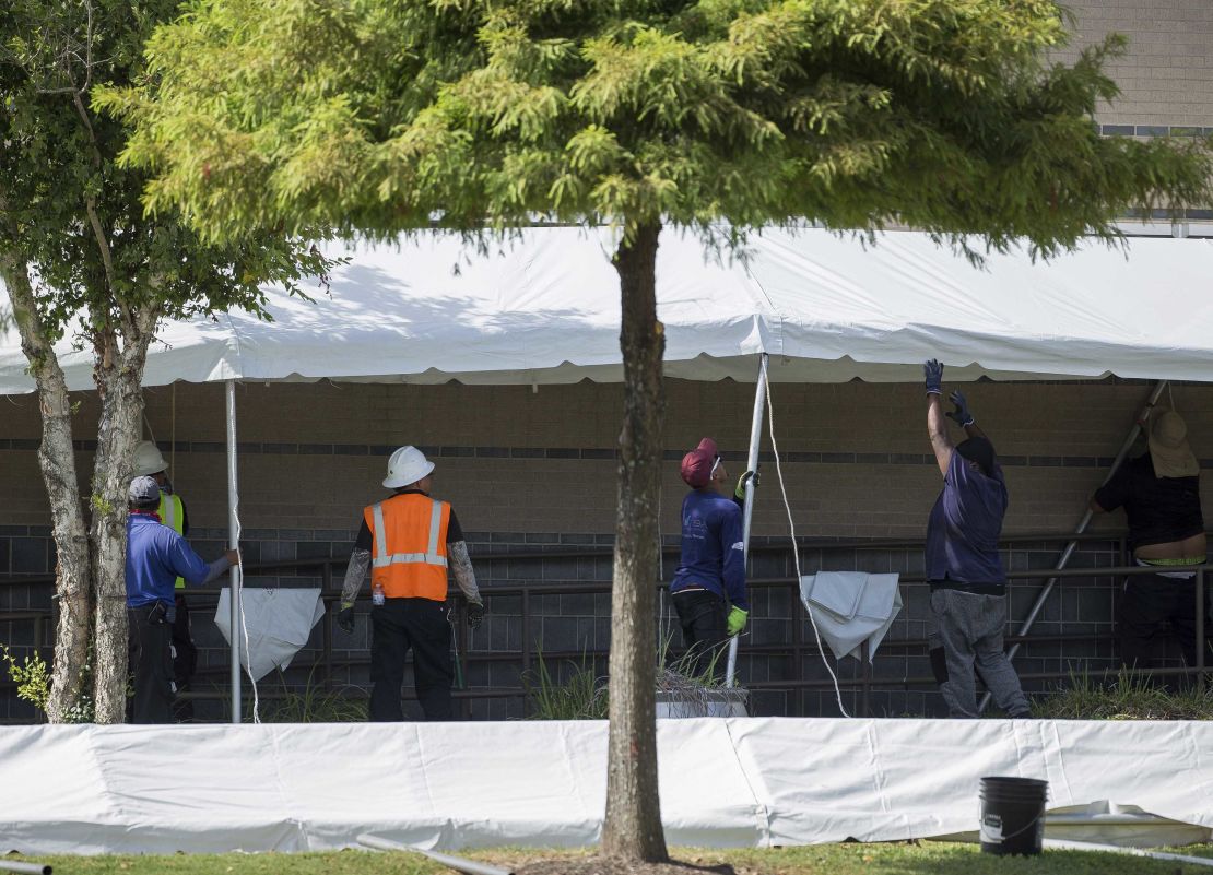 A construction crew works to set up tents that hospital officials plan to use with an overflow of Covid-19 patients outside of Lyndon B. Johnson Hospital, Monday, Aug. 9, 2021, in Houston. 