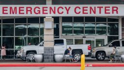 HOUSTON, TEXAS - AUGUST 10: People wait outside of the Lyndon B. Johnson Hospital on August 10, 2021 in Houston, Texas. The Lyndon B. Johnson Hospital has set up medical tents in preparation for an overflow of patients being treated for the COVID-19 Delta variant. The Houston metropolitan area has seen an upward increase of Delta infections, and research is showing the Delta variant to be 60% more contagious than its predecessor the Alpha variant, also known as COVID-19. (Photo by Brandon Bell/Getty Images)