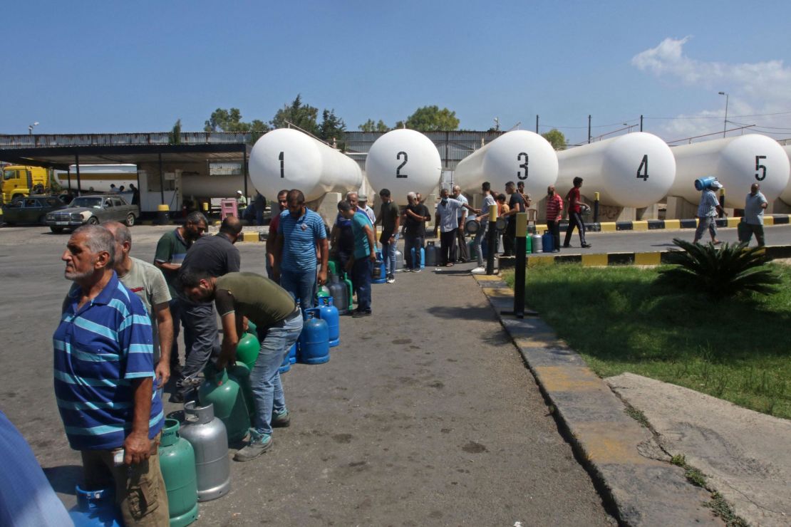 Lebanese wait to fill their gas cylinders in the southern city of Sidon, on August 10.