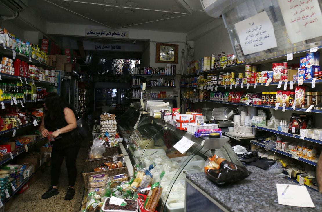 A woman shops in a store without electricity due to shortages in Beirut on August 11.