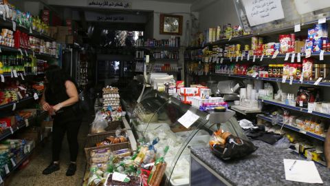 A woman shops in a store without electricity due to shortages in Beirut on August 11.