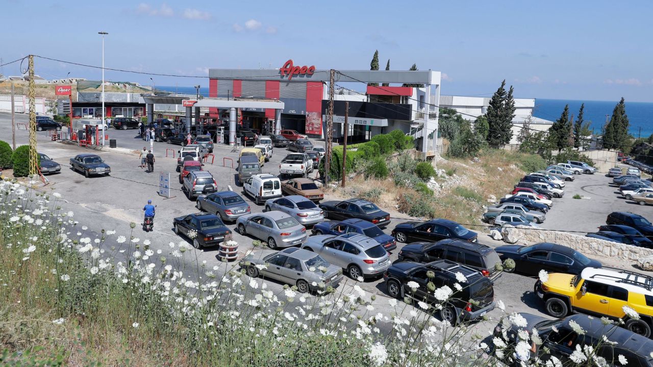 Vehicles line up at a petrol station in the Balamand area on the coastal highway linking Lebanon's capital to the country's north, on June 21, 2021 amid dire fuel shortages.