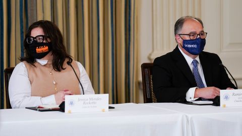 Jess Morales Rocketto, civic engagement director of the National Domestic Workers Alliance, (left), and Ramiro Cavazos, president and CEO of the US Hispanic Chamber of Commerce, listen as President Joe Biden speaks during a meeting with Latino leaders in the White House on August 3, 2021.