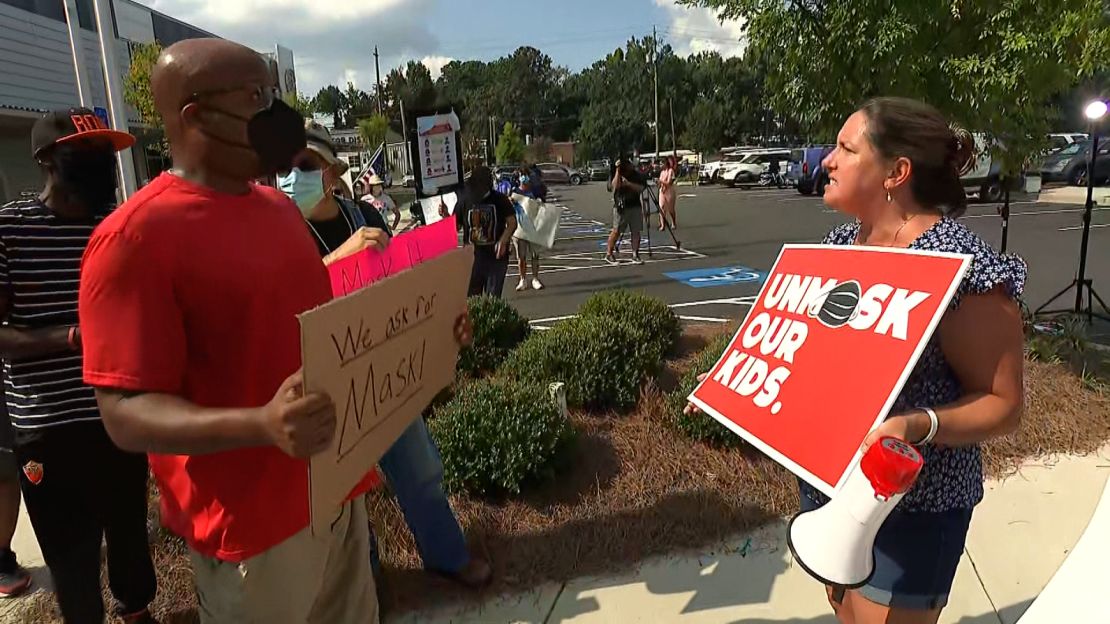 Two protesters clash at the Cobb County School District central office in Marietta last week.