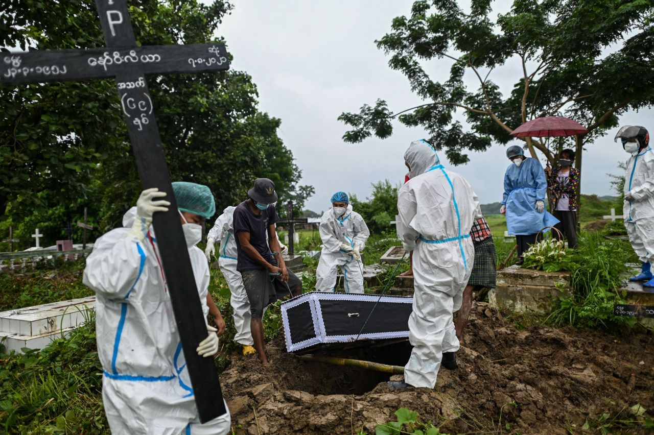 Volunteers bury a suspected Covid-19 victim at a cemetery in Myanmar's Taungoo district on Saturday, August 7.