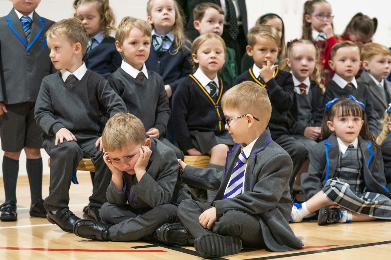 Thirteen sets of twins due to start the new school year pose for a photo at St. Mary's Primary School in Greenock, Scotland, on Wednesday, August 11.