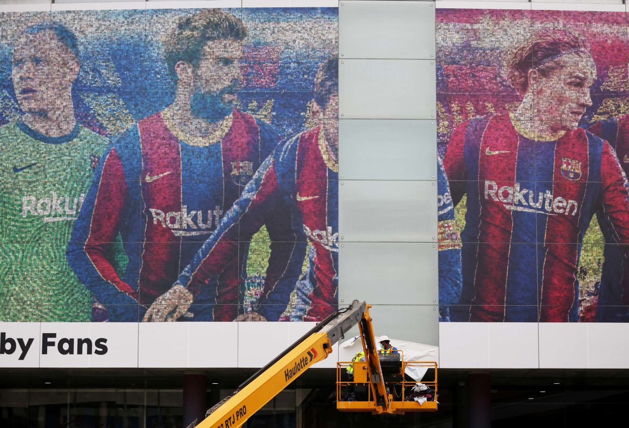 An image of Lionel Messi is taken down outside the Camp Nou stadium in Barcelona, Spain, on Tuesday, August 10. Messi, one of the greatest soccer players of all time, <a href="https://www.cnn.com/2021/08/10/football/lionel-messi-psg-barcelona-reports-spt-intl/index.html" target="_blank">is leaving FC Barcelona to play for Paris Saint-Germain.</a>