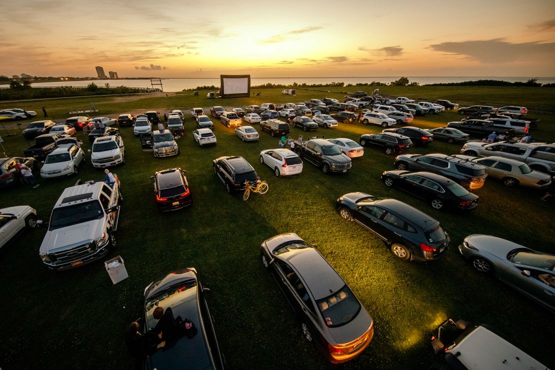 Attendees arrive to watch the movie "Grease" at a pop-up drive-in theatre at Bucktown Marina Park on May 22, 2020 in Metairie, Louisiana. With indoor theaters in many places closed due to coronavirus, drive-in theaters saw a rise in attendance. 
