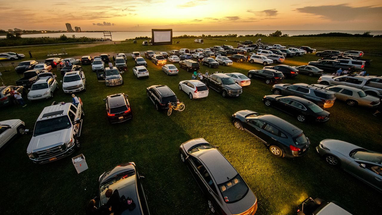 Attendees arrive to watch the movie "Grease" at a pop-up drive-in theatre at Bucktown Marina Park on May 22, 2020 in Metairie, Louisiana. With indoor theaters in many places closed due to coronavirus, drive-in theaters saw a rise in attendance. 