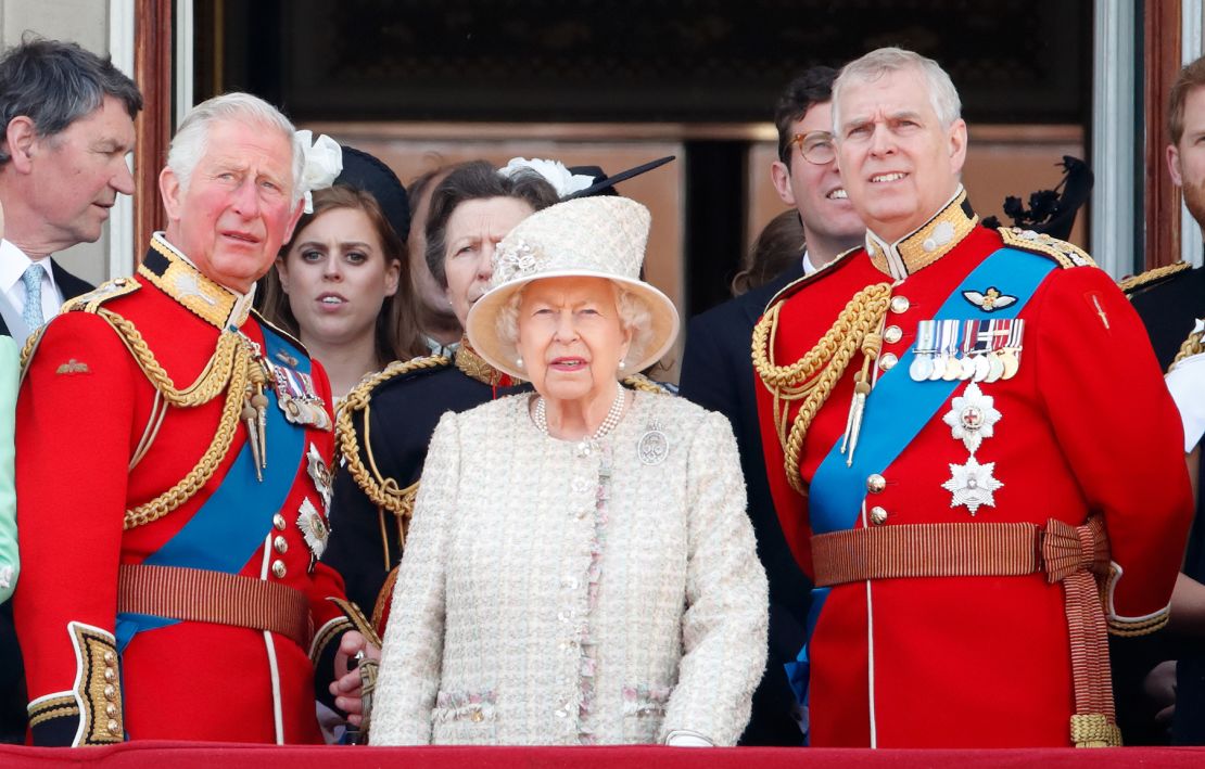 The Queen stands with Princes Charles and Andrew during a flypast of Buckingham Palace in 2019. 