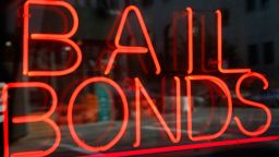 FILE - This July 7, 2015, file photo, shows a sign advertising a bail bonds business in the Brooklyn borough of New York. A new Texas nonprofit promoting crime victims' rights is opposing bipartisan efforts to end cash bail systems that have gained traction around the country - hitting back at one of the few issues that unified advocates on both the right and left. Kicking off Thursday, Feb. 15, 2018, the Texas Alliance for Safe Communities wants to strengthen public safety and curb violent crime. (AP Photo/Kathy Willens, File)