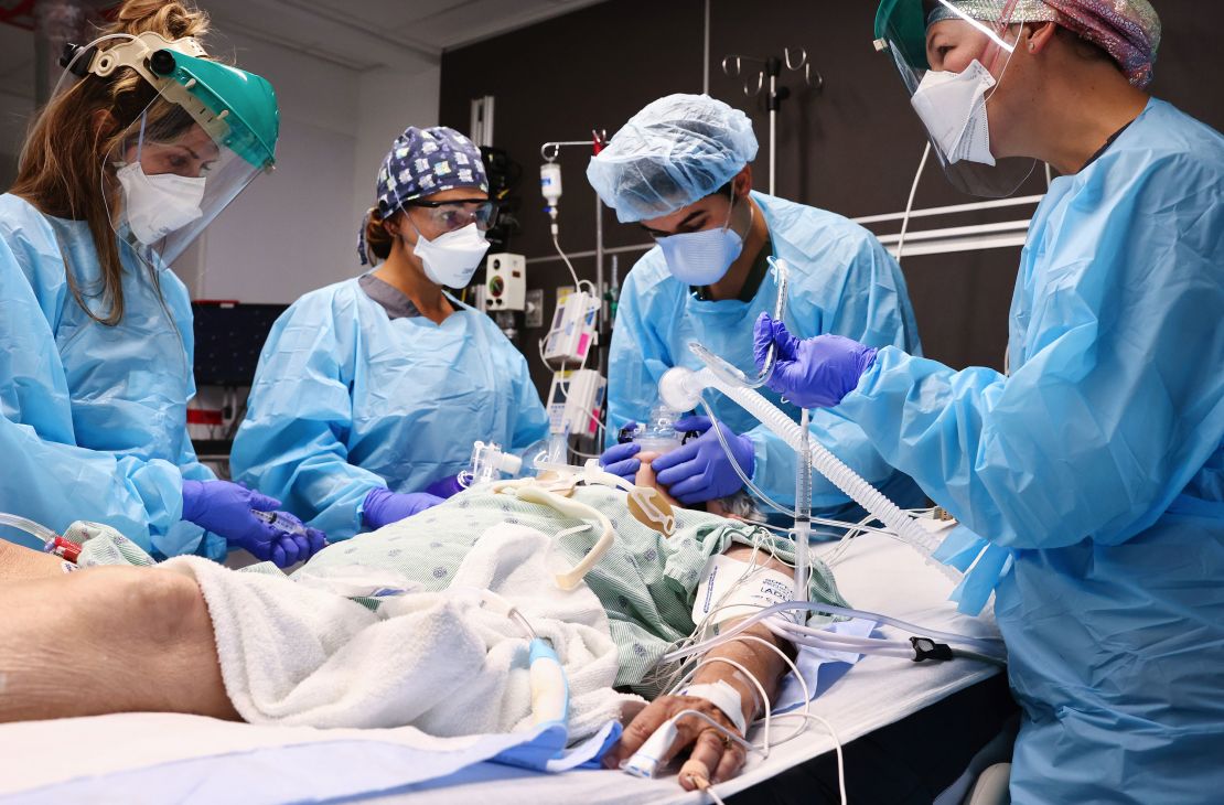 Clinicians work on intubating a Covid-19 patient Tuesday in the intensive care unit at Lake Charles Memorial Hospital in Lake Charles, Louisiana, Tuesday, August 10.