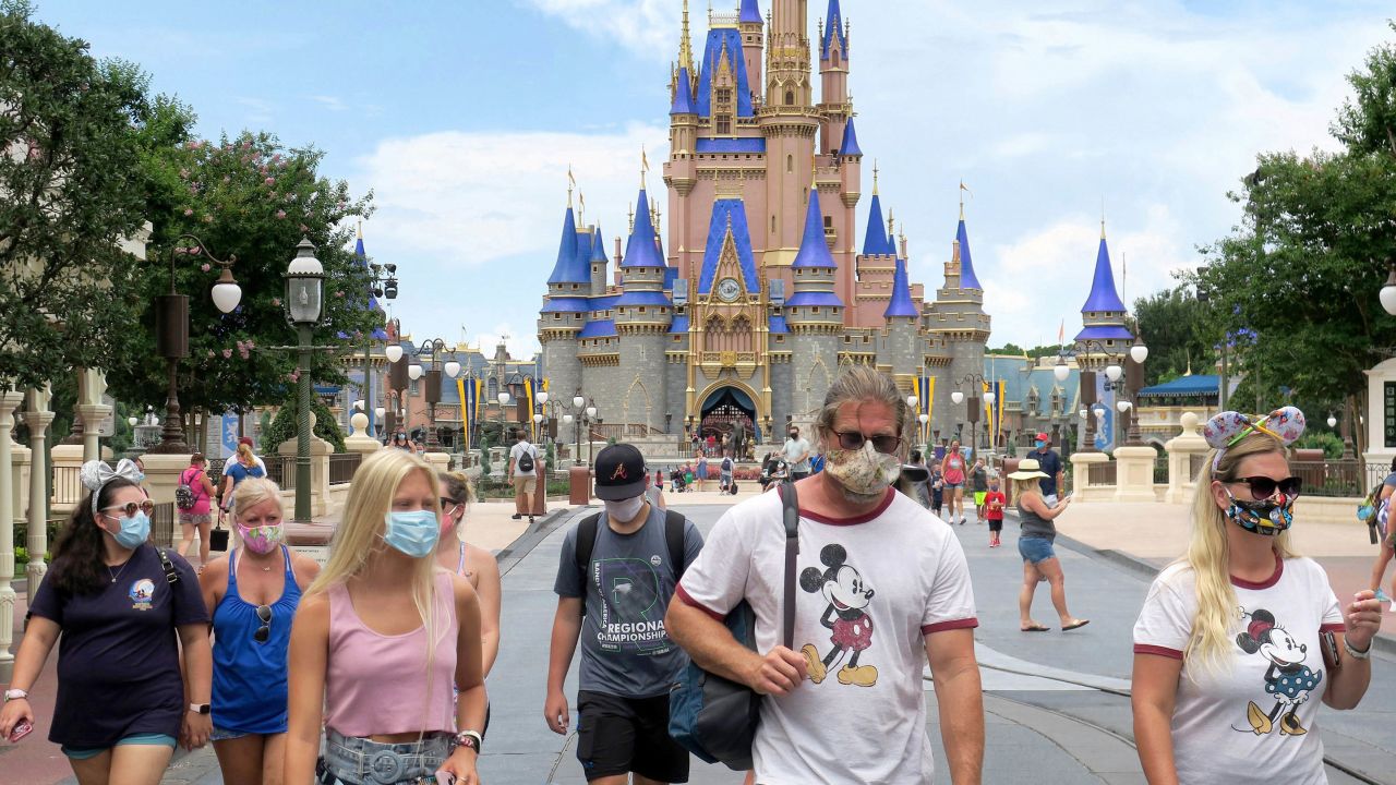 In this file photo, guests wear masks at Walt Disney World in Florida.