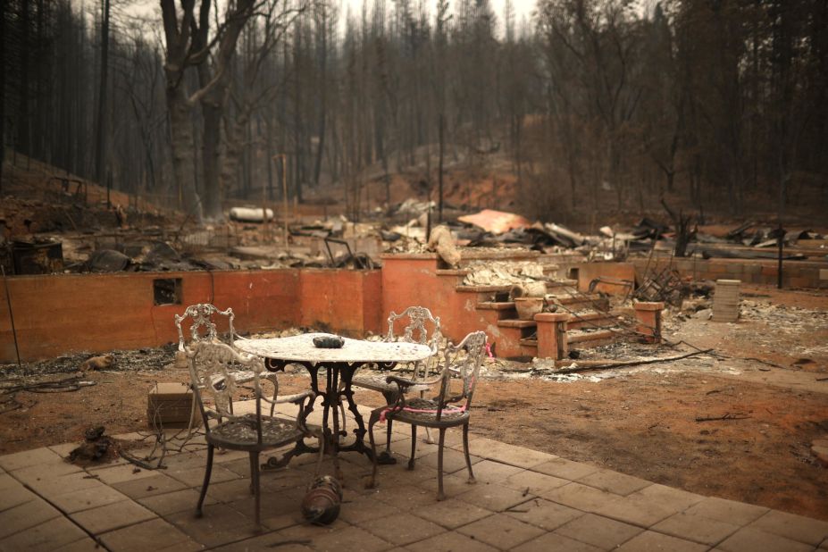 A table and chairs sit in front of a destroyed home in Greenville, California, on August 12.