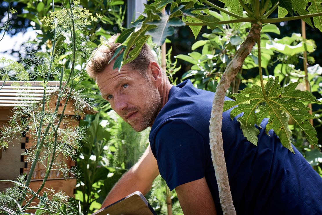 Joost Bakker tends to the beehive  on the Greenhouse's roof terrace.