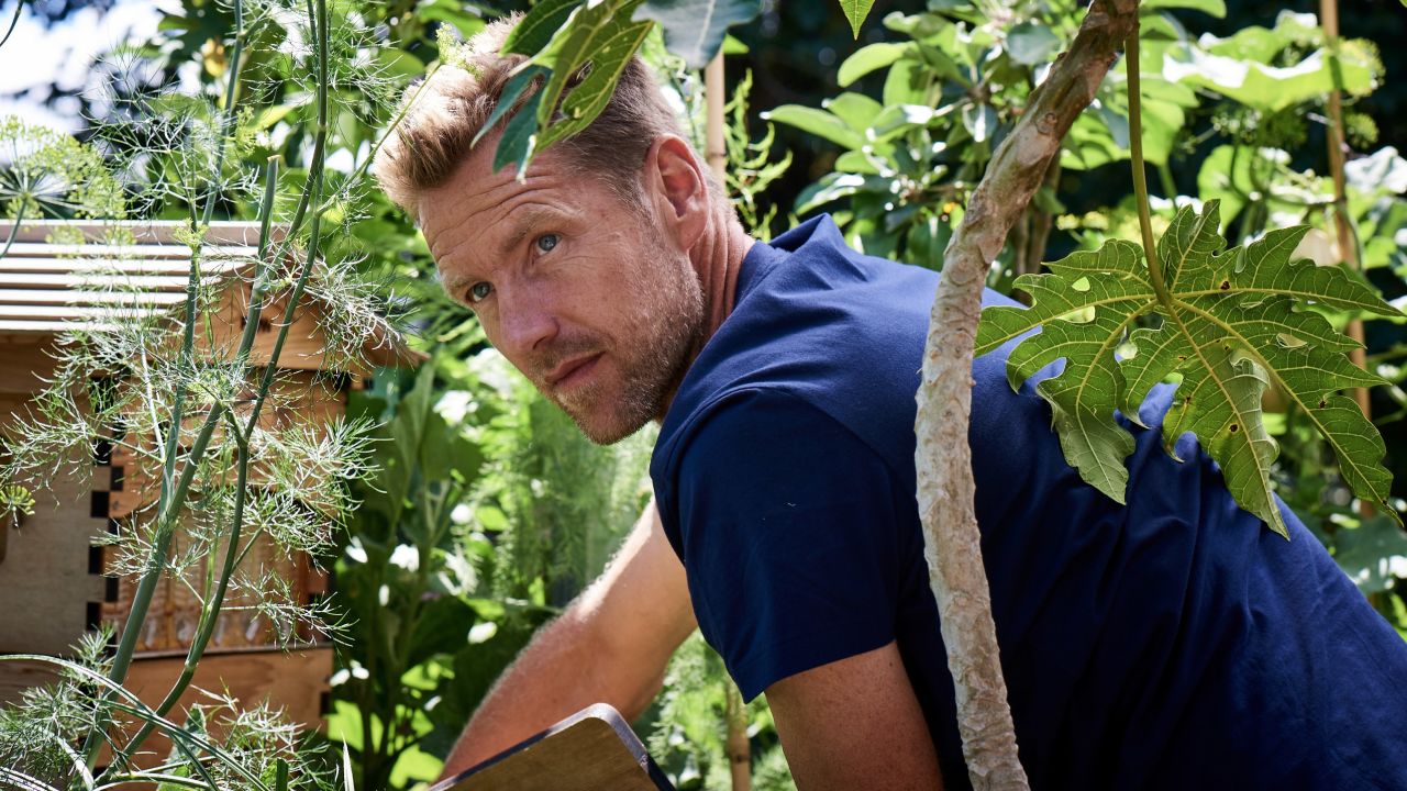 Joost Bakker tends to the beehive on the Greenhouse's roof terrace.