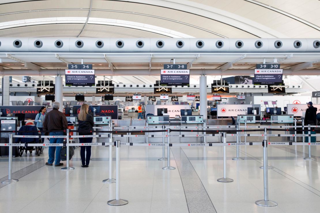 Passengers at check-in at Toronto Pearson International Airport in April 2020.