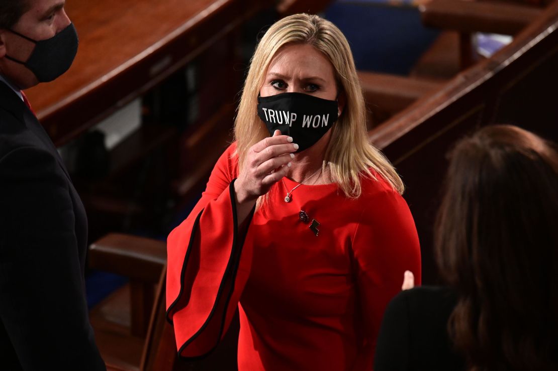 US Rep. Marjorie Taylor Greene wears a "Trump Won" face mask as she arrives on the floor of the House to take her oath of office as a newly elected member of the 117th House of Representatives in Washington on January 3, 2021. 