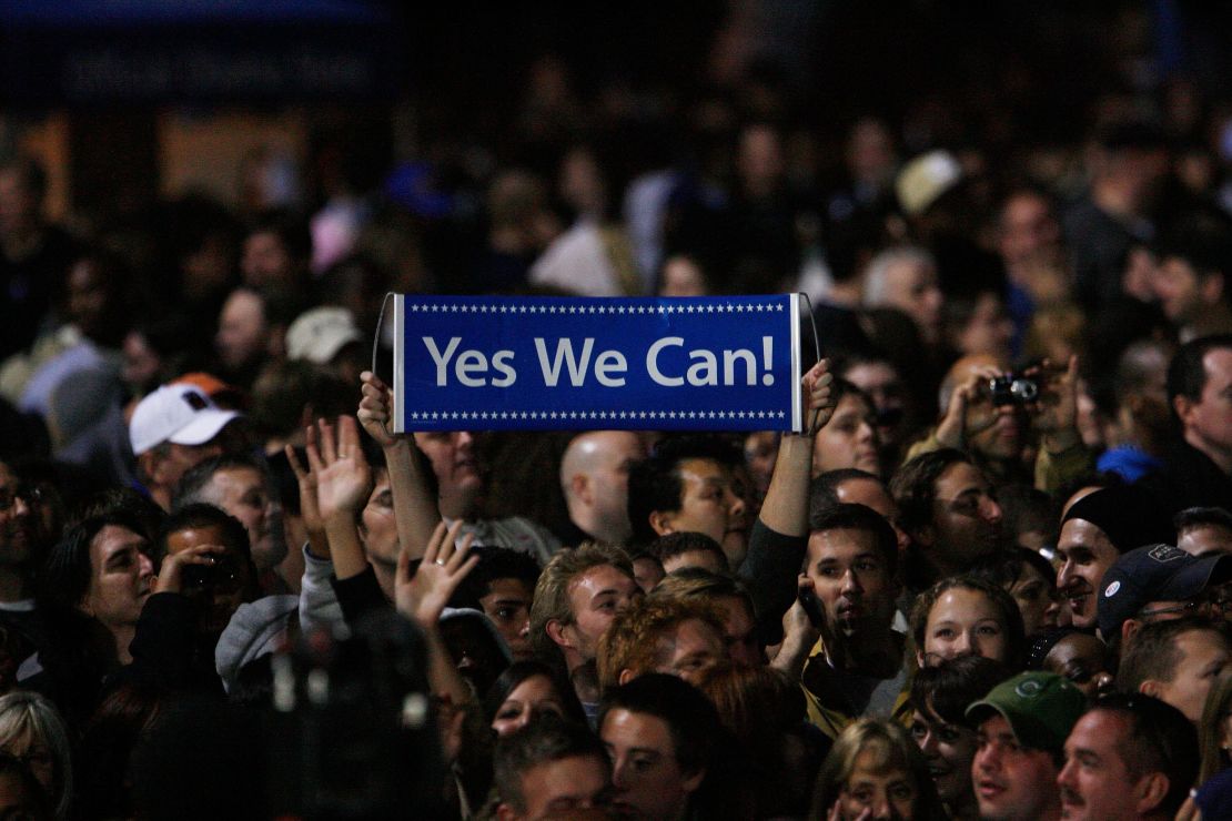 An Obama supporter holds up a sign reading "Yes we can" as  President-elect Barack Obama gives his election night victory speech on November 4, 2008, in Chicago's Grant Park. 